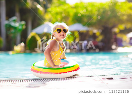 Child in swimming pool. Kids swim. Water play. 115521126