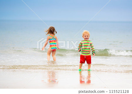 Kids playing on beach. Children play at sea. 115521128