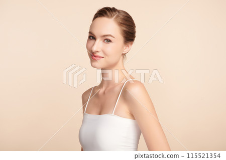 Beautiful young woman with clean fresh skin on beige background, Face care, Facial treatment, Cosmetology, beauty and spa, women portrait. Beautiful young woman with clean fresh skin on beige background, Face care, Facial treatment, Cosmetology, beauty and spa, women portrait. 115521354