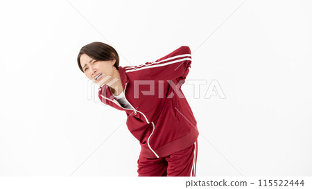 Woman in tracksuit with back pain Woman in tracksuit with back pain 115522444