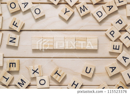 A wooden board with a crossword puzzle on it 115523376