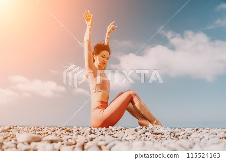 Middle aged well looking woman with black hair, fitness instructor in leggings and tops doing stretching and pilates on yoga mat near the sea. Female fitness yoga routine concept. Healthy lifestyle 115524163