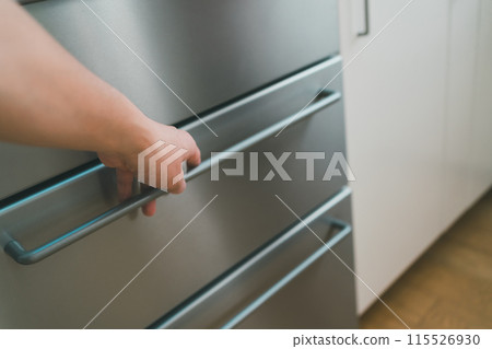 The hands of a man in his 40s opening a refrigerator The hands of a man in his 40s opening a refrigerator 115526930