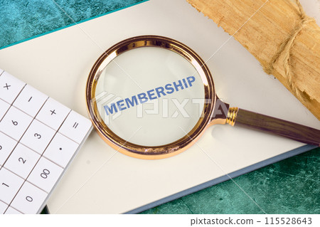 Business concept. MEMBERSHIP - word through a magnifying glass on a blank sheet of notepad next to a calculator and a roll of papyrus Business concept. MEMBERSHIP - word through a magnifying glass on a blank sheet of notepad next to a calculator and a roll of papyrus 115528643