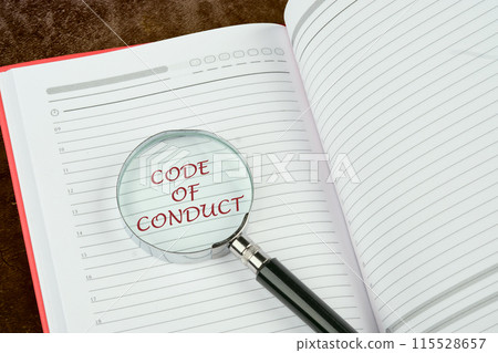 CODE OF CONDUCT words written through a magnifying glass in the notebook of a businessman, manager, teacher CODE OF CONDUCT words written through a magnifying glass in the notebook of a businessman, manager, teacher 115528657