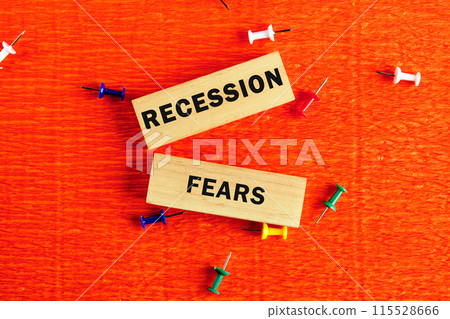 Business and recession fears concept. Copy space. RECESSION FEARS written conceptual words on the wooden blocks . Beautiful orange background Business and recession fears concept. Copy space. RECESSION FEARS written conceptual words on the wooden blocks . Beautiful orange background 115528666