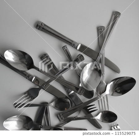 Mix Of Silvery Forks, Knives And Spoons For Eating Closeup View. Photo For Cutlery Concept Backgrounds Mix Of Silvery Forks, Knives And Spoons For Eating Closeup View. Photo For Cutlery Concept Backgrounds 115529075
