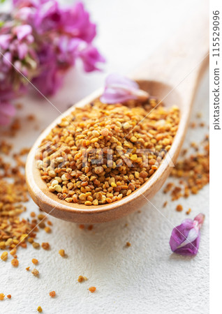 Healthy bee pollen grains.  Bee pollen on a wooden spoon 115529096