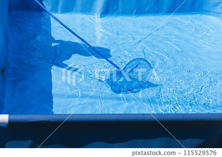 bright blue pool being cleaned, highlighting the tranquility and beauty of clear 115529576