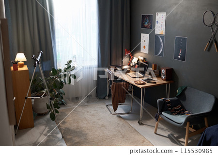 Wide angle shot of teenage boys room interior with workplace desk and hobby equipment for astronomy and sports copy space Wide angle shot of teenage boys room interior with workplace desk and hobby equipment for astronomy and sports copy space 115530985
