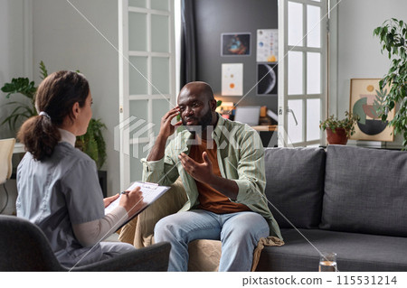 Portrait of adult African American man talking to psychotherapist in one on one session copy space Portrait of adult African American man talking to psychotherapist in one on one session copy space 115531214