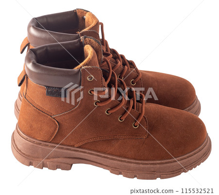 Brown suede boots isolated on white background. Shoes for autumn and winter unisex casual. A pair of boots with laces and tractor soles Brown suede boots isolated on white background. Shoes for autumn and winter unisex casual. A pair of boots with laces and tractor soles 115532521