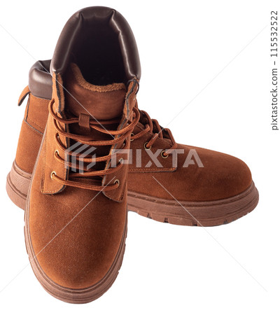 Brown suede boots isolated on white background. Shoes for autumn and winter unisex casual. A pair of boots with laces and tractor soles 115532522