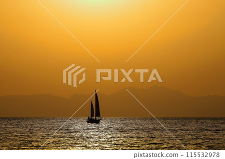 黃昏時的逗子海岸線變成橘色，遊艇的輪廓隨風而行 115532978