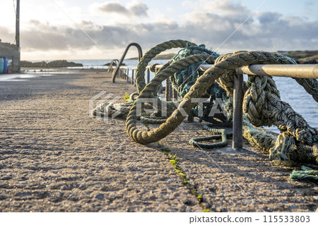 Ropes and ladder into the sea at coastal harbour 115533803