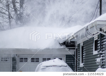 Snow blowing off the roof of a residential house during a blizzard Snow blowing off the roof of a residential house during a blizzard 115534029