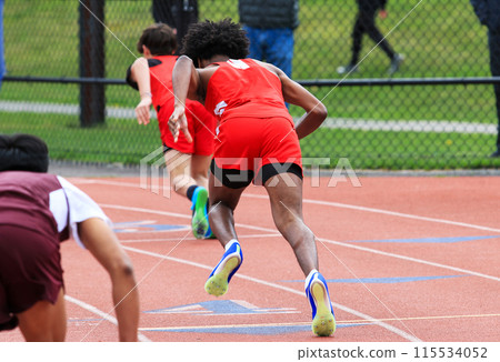 Track Sprinter runner starting a race in lanes 115534052