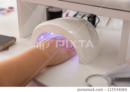 UV lamp gel polish manicure process. UV lamp gel polish manicure process. 115534069