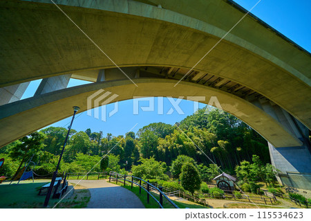 View of Kamiyato Bridge in Wakabadai, Inagi City, Tokyo, from the park's footpath towards the watermill View of Kamiyato Bridge in Wakabadai, Inagi City, Tokyo, from the park's footpath towards the watermill 115534623
