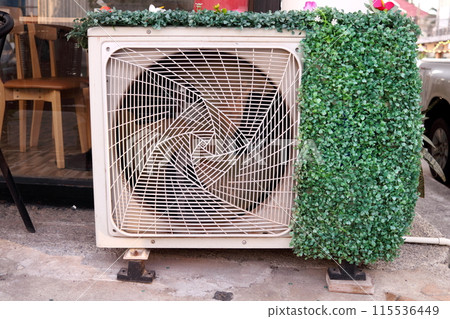 Air condition compressor covered artificial plant. Air condition compressor covered artificial plant. 115536449