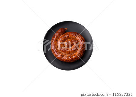 Delicious homemade sausage in the form of a spiral baked on the grill with salt, spices Delicious homemade sausage in the form of a spiral baked on the grill with salt, spices 115537325