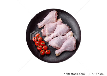 Raw chicken legs with salt, spices and herbs 115537382