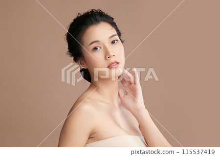 Beautiful young asian woman with clean fresh skin on beige background, Face care, Facial treatment, Cosmetology, beauty and spa, Asian women portrait. 115537419