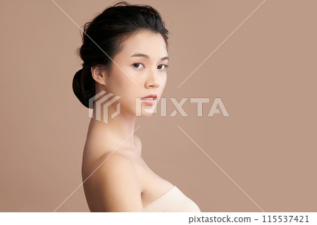 Beautiful young asian woman with clean fresh skin on beige background, Face care, Facial treatment, Cosmetology, beauty and spa, Asian women portrait. 115537421