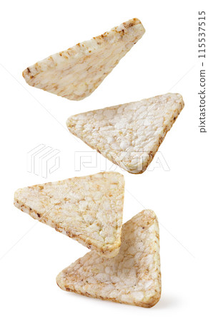 Rice crisps triangles falling on white background. Isolated 115537515