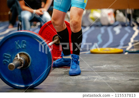 legs woman athlete in black knee socks near barbell deadlift 115537813