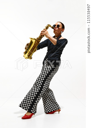 Woman, musician in retro checkered pants and stylish shoes performs a jazz, playing saxophone isolated on white background Woman, musician in retro checkered pants and stylish shoes performs a jazz, playing saxophone isolated on white background 115538497