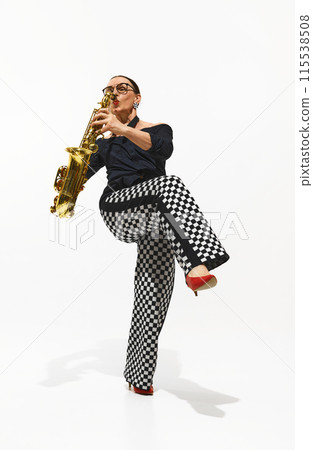Dynamic image of elegant woman, stylish saxophonist playing saxophone with soul and energy isolated on white background Dynamic image of elegant woman, stylish saxophonist playing saxophone with soul and energy isolated on white background 115538508
