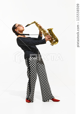 Stylish woman, musician in visually striking outfit plays the saxophone with passion and style isolated on white background Stylish woman, musician in visually striking outfit plays the saxophone with passion and style isolated on white background 115538509