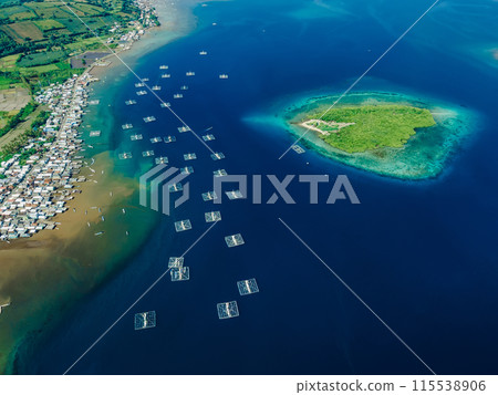 Indonesian village and fishing boats in ocean on Sumbawa island. Scenic drone view. 115538906