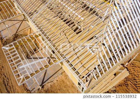 Building construction, is wooden beams framing new home under construction roof wall being built 115538932