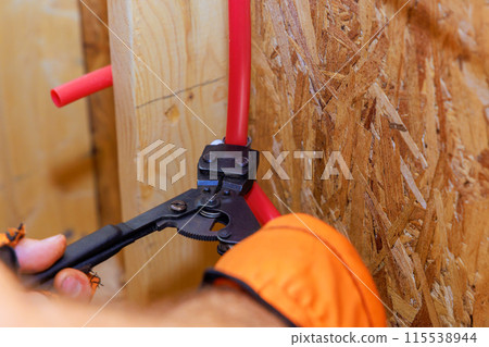 Assemble installation of PVC plastic water pipes in wall of residence by plumber Assemble installation of PVC plastic water pipes in wall of residence by plumber 115538944