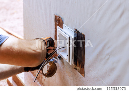 Weatherproof deep plastic electrical box is mounted on outside wall 115538973