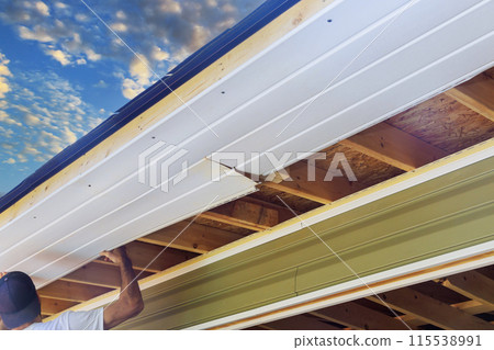 Vinyl soffit plastic boards mounted to roof rafters Vinyl soffit plastic boards mounted to roof rafters 115538991