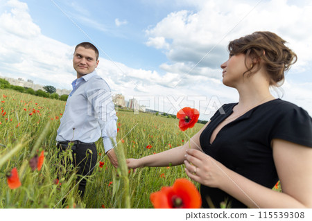 Young couple in love and happy among the flowers in the field. Young couple in love and happy among the flowers in the field. 115539308