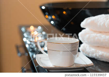 Burning candles and pile of towels Burning candles and pile of towels 115539437