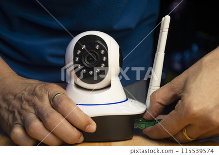 Conceptual man operating ip camera Conceptual man operating ip camera 115539574