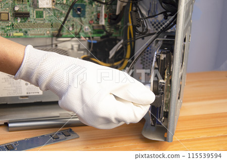 side view technician repairing computer 115539594