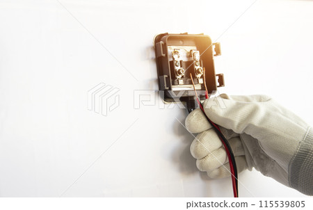 Technicians are connecting wires to solar panels. Technicians are connecting wires to solar panels. 115539805