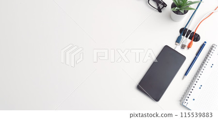 Office desktop with smartphone and accessories Office desktop with smartphone and accessories 115539883