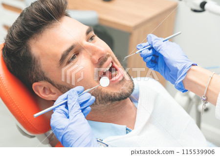 Handsome young man in stomatology clinic Handsome young man in stomatology clinic 115539906