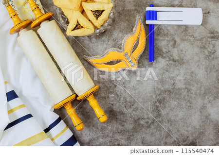 Purim celebration jewish holiday carnival with happy decoration a hamantaschen cookies shofar tallit carnival masks 115540474