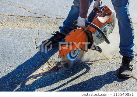 An asphalt has been damaged by use of diamond blade saw in parking lot An asphalt has been damaged by use of diamond blade saw in parking lot 115540881