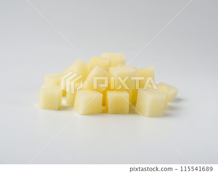 Heap of diced raw potatoes isolated on white background. Pile uncooked potatoes cube. Heap of diced raw potatoes isolated on white background. Pile uncooked potatoes cube. 115541689