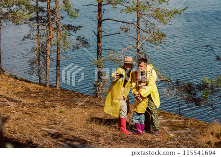The family is traveling. Dad, mom, and child are walking around the stone island admiring nature. Childhood and a pleasant time together. 115541694