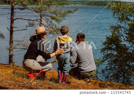 The family is traveling. Dad, mom, and child are walking around the stone island admiring nature. Childhood and a pleasant time together. 115541743